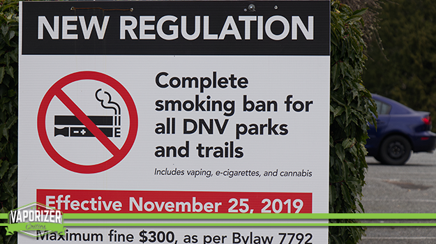 A sign in North Vancouver Canada park warning of vaping ban in parks and trails.